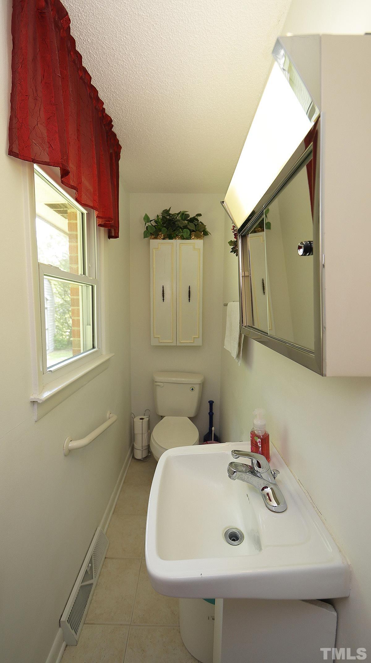 7121 Riley Hill Road Wendell, NC 27591 - Photo 11 of 16 a bathroom with a sink and a mirror