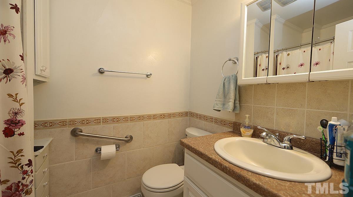 7121 Riley Hill Road Wendell, NC 27591 - Photo 13 of 16 a bathroom with a sink a toilet and shower