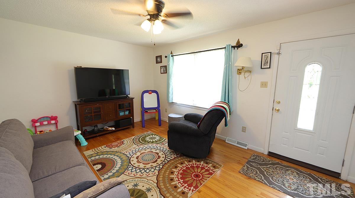 7121 Riley Hill Road Wendell, NC 27591 - Photo 3 of 16 a living room with furniture and a flat screen tv