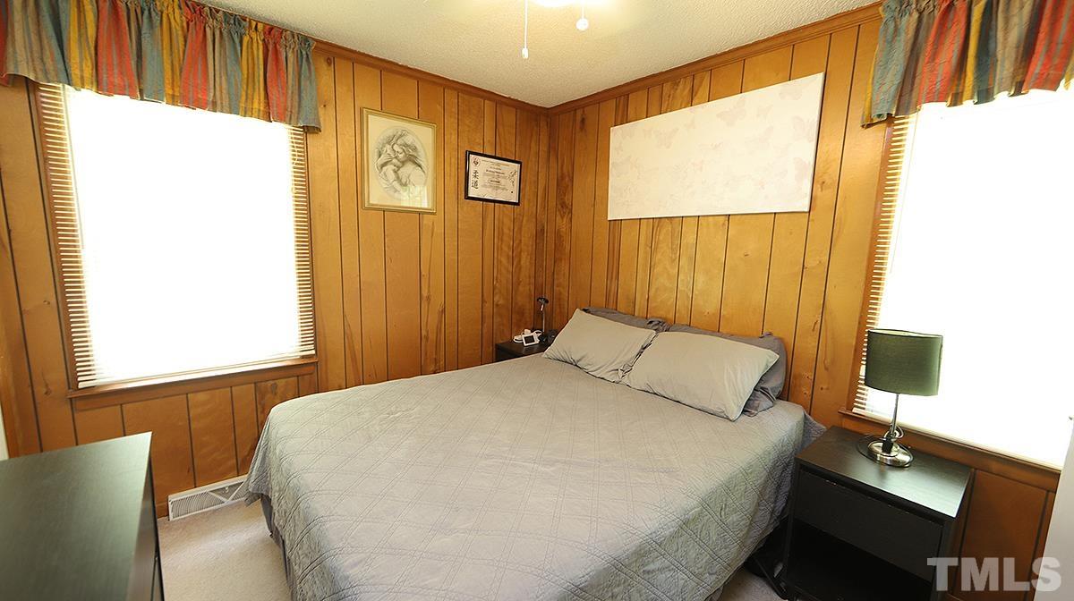 7121 Riley Hill Road Wendell, NC 27591 - Photo 7 of 16 a bedroom with a bed and a window