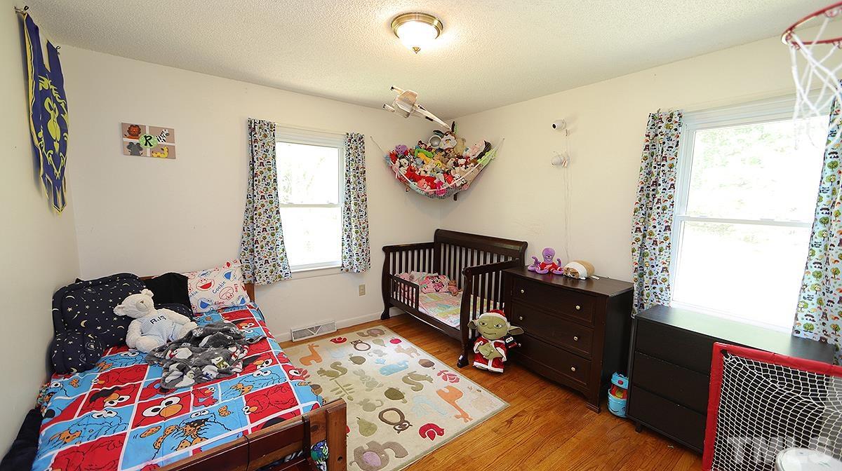 7121 Riley Hill Road Wendell, NC 27591 - Photo 9 of 16 a bedroom with a bed and a window