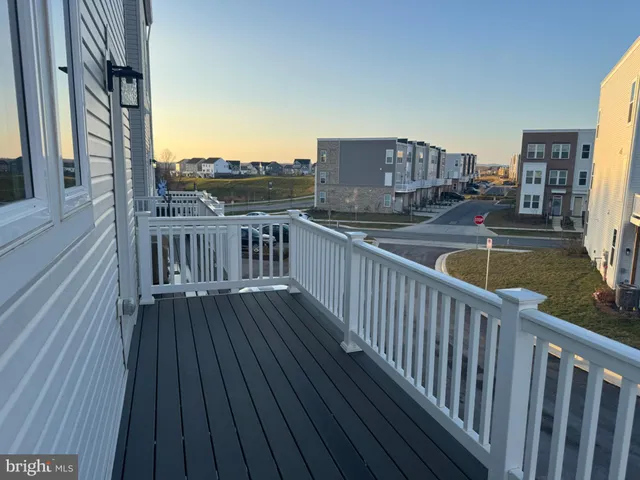 a view of balcony with wooden floor and fence