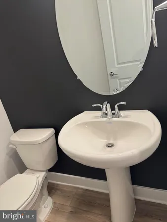 a white toilet sitting next to a bathroom sink