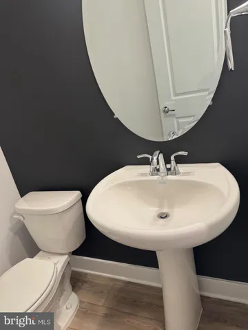a white toilet sitting next to a bathroom sink