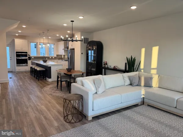 a living room with furniture and kitchen view