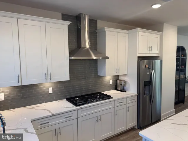 a kitchen with granite countertop a sink stove and refrigerator