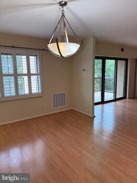 205 Yoakum Parkway, Unit 626 Alexandria, VA 22304 - Photo 17 of 83 a view of an empty room with a window and wooden floor