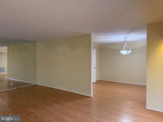205 Yoakum Parkway, Unit 626 Alexandria, VA 22304 - Photo 19 of 83 an empty room with wooden floor and windows