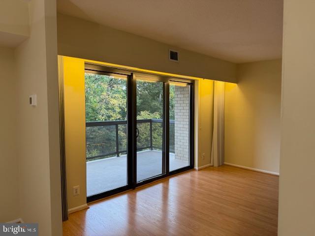 205 Yoakum Parkway, Unit 626 Alexandria, VA 22304 - Photo 20 of 83 a view of an empty room with wooden floor and a window