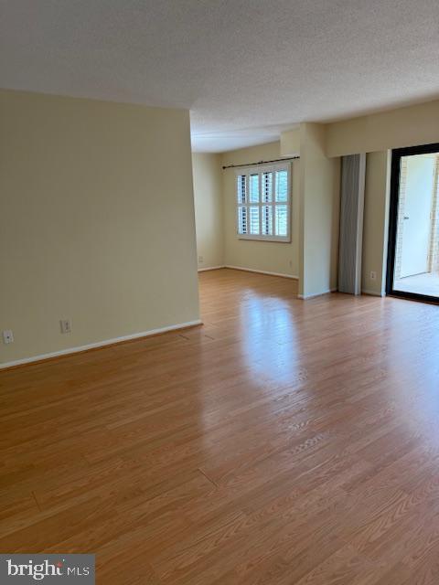 205 Yoakum Parkway, Unit 626 Alexandria, VA 22304 - Photo 22 of 83 a view of an empty room with wooden floor and a window