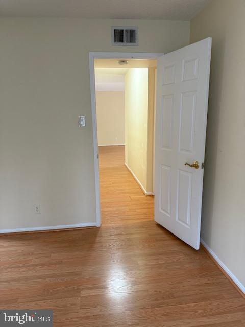 205 Yoakum Parkway, Unit 626 Alexandria, VA 22304 - Photo 27 of 83 an empty room with wooden floor and a window