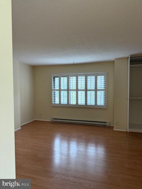 205 Yoakum Parkway, Unit 626 Alexandria, VA 22304 - Photo 28 of 83 an empty room with wooden floor and windows