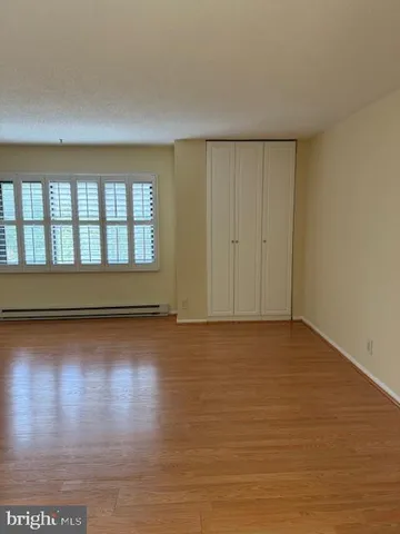 an empty room with a empty space and windows