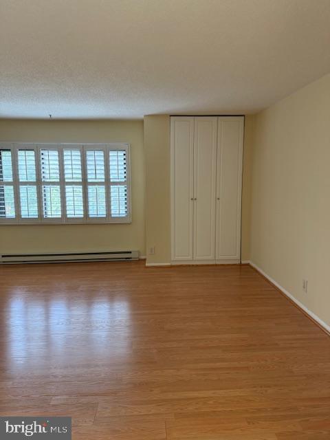 205 Yoakum Parkway, Unit 626 Alexandria, VA 22304 - Photo 31 of 83 a view of an empty room with wooden floor and a window