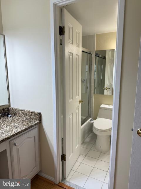 205 Yoakum Parkway, Unit 626 Alexandria, VA 22304 - Photo 42 of 83 a bathroom with a granite countertop sink a toilet and a shower