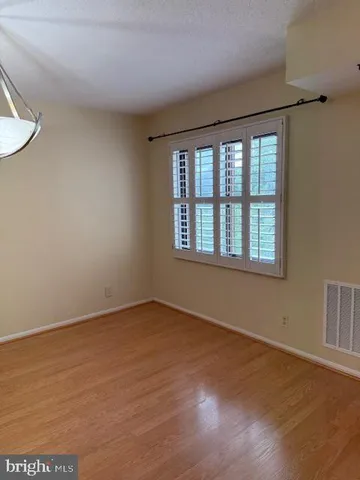 a living room with a couch and a table with wooden floor