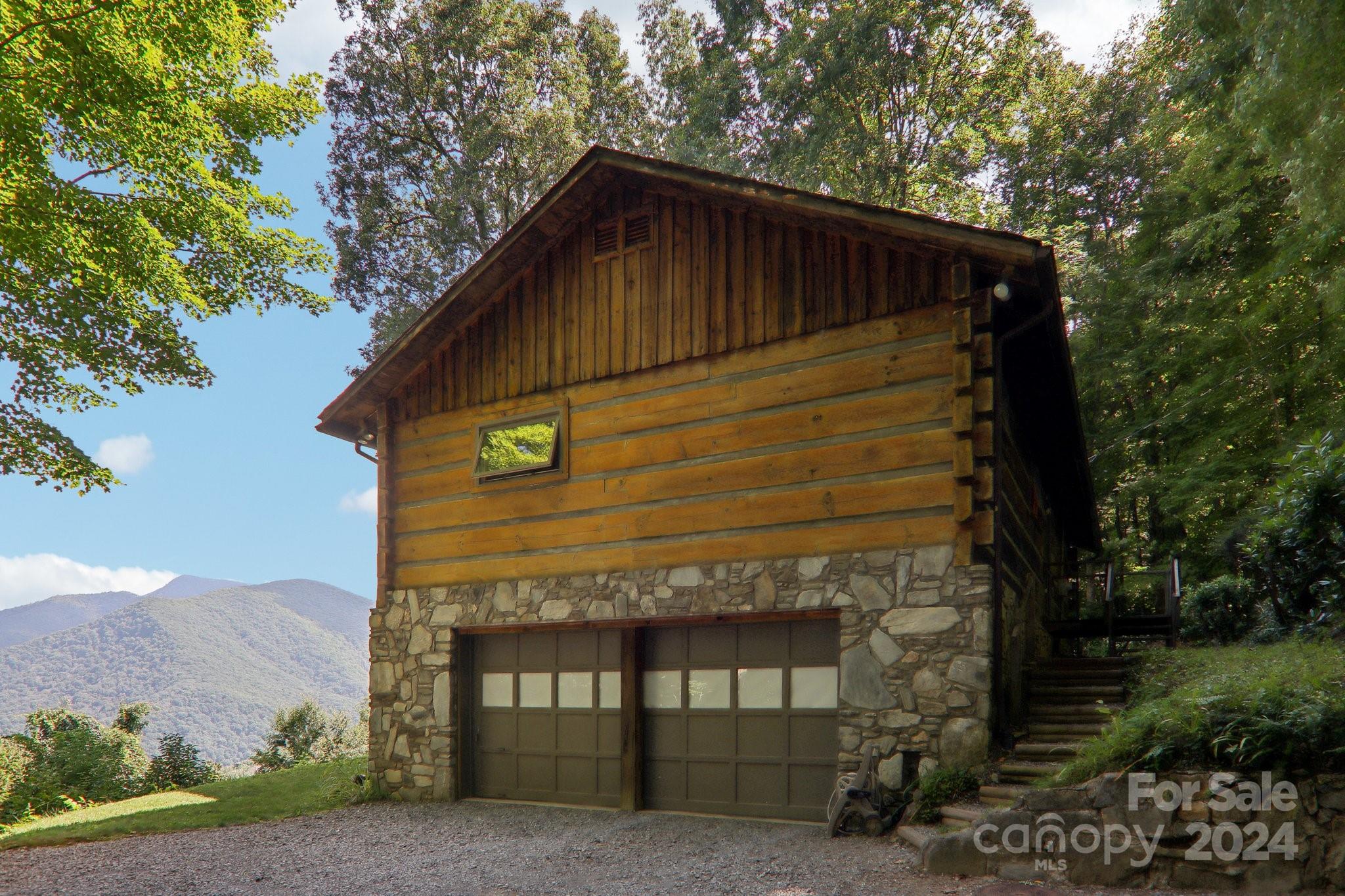 1685 Setzercove Road Maggie Valley, NC 28751 - Photo 1 of 42 a front view of a house with a garden