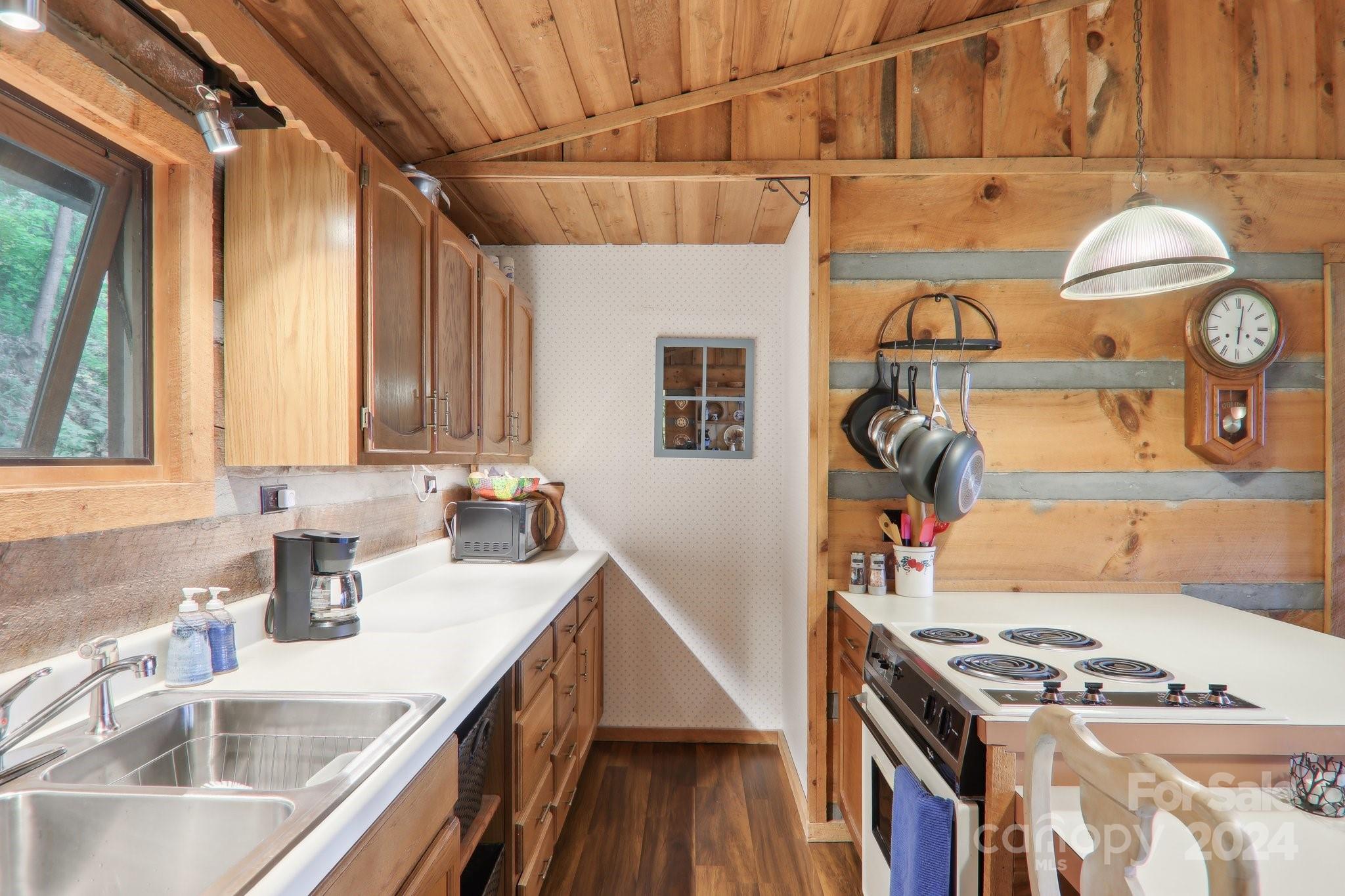 1685 Setzercove Road Maggie Valley, NC 28751 - Photo 13 of 42 a kitchen with stainless steel appliances granite countertop a sink stove and cabinets