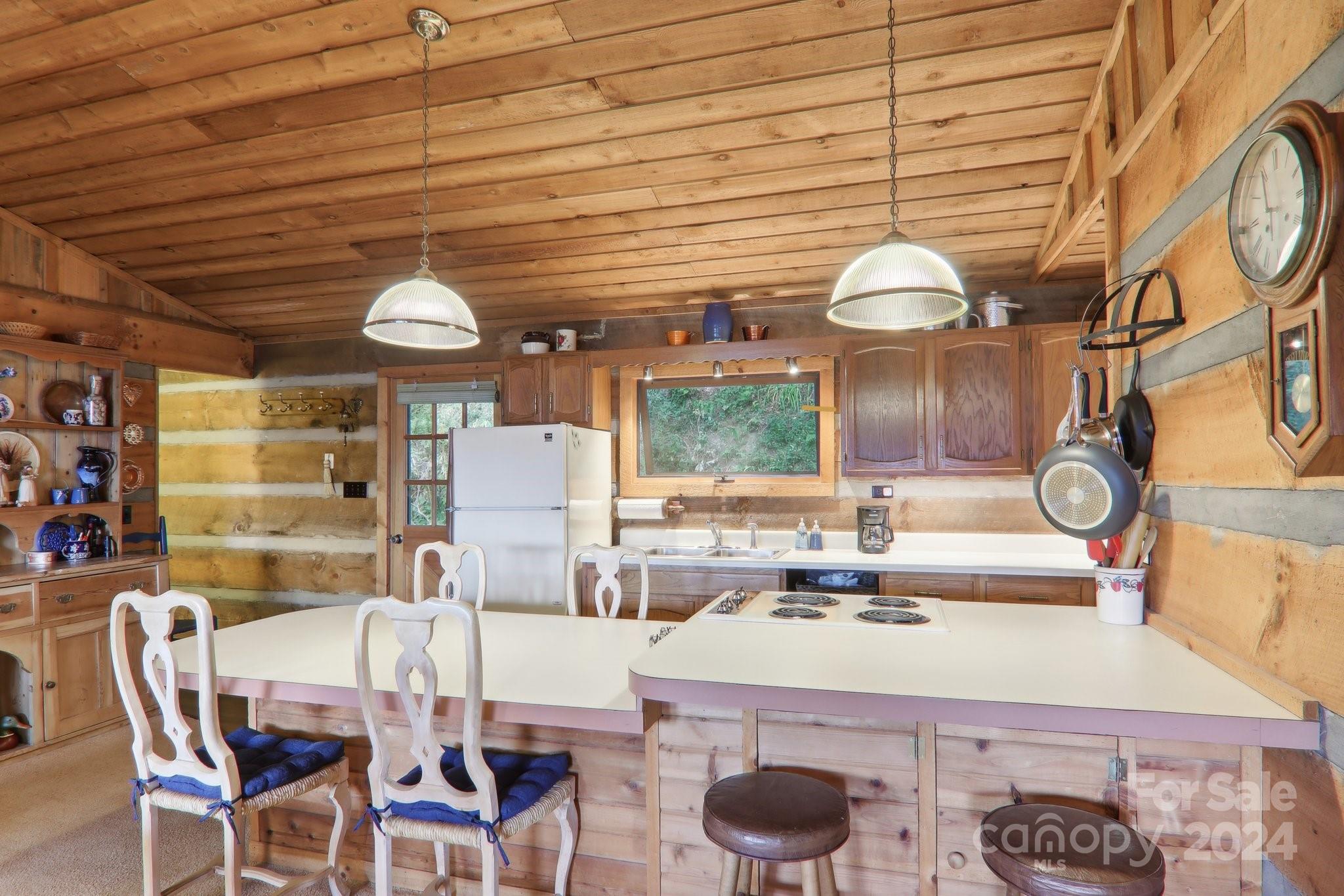1685 Setzercove Road Maggie Valley, NC 28751 - Photo 15 of 42 a kitchen with a table and chairs in it