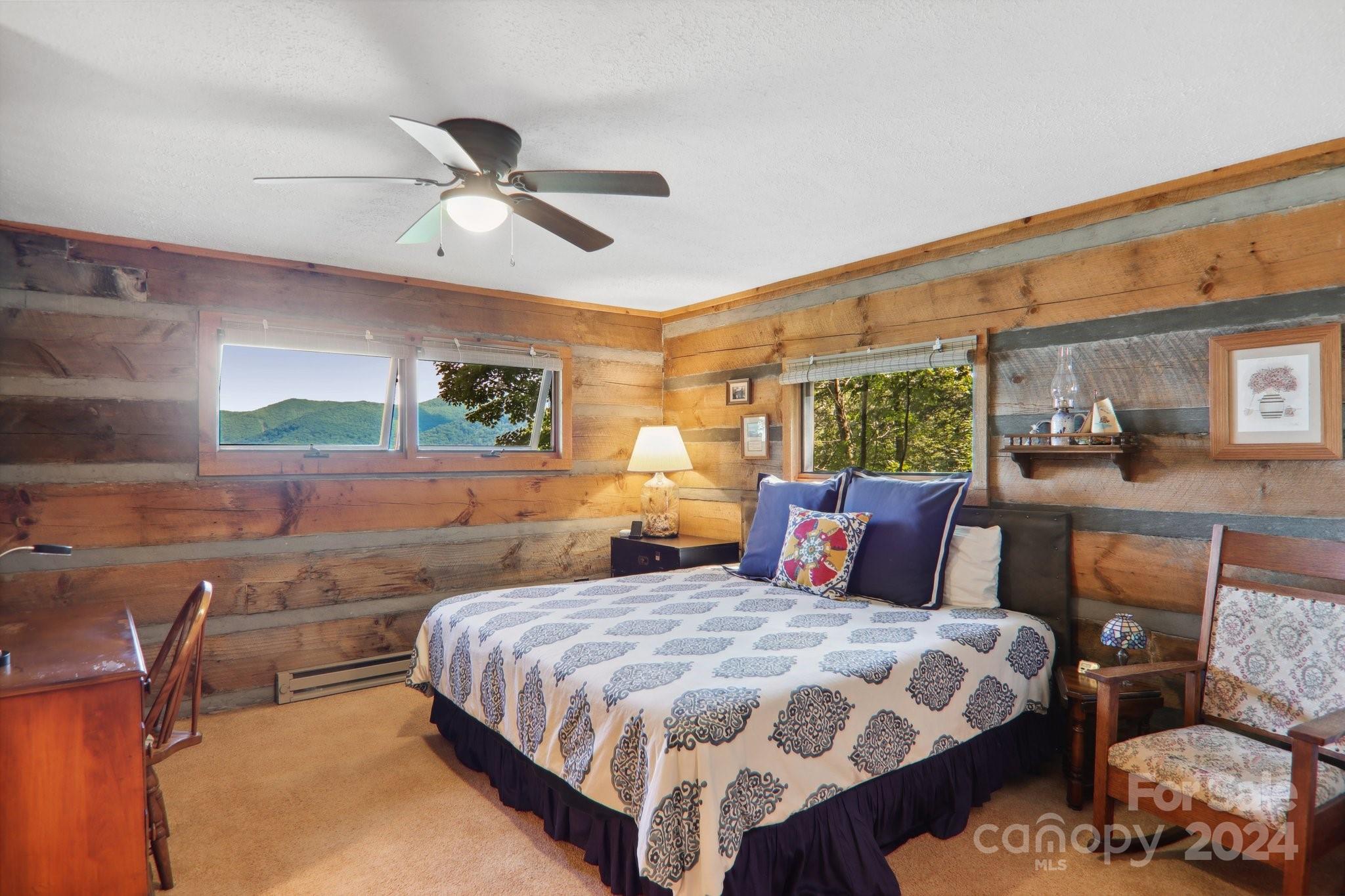 1685 Setzercove Road Maggie Valley, NC 28751 - Photo 17 of 42 a bedroom with a bed a couch and dresser