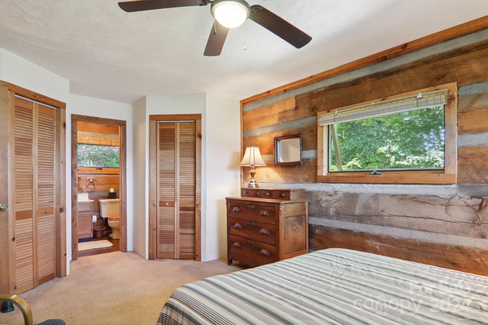 1685 Setzercove Road Maggie Valley, NC 28751 - Photo 23 of 42 a bedroom with a bed and a dresser next to a window