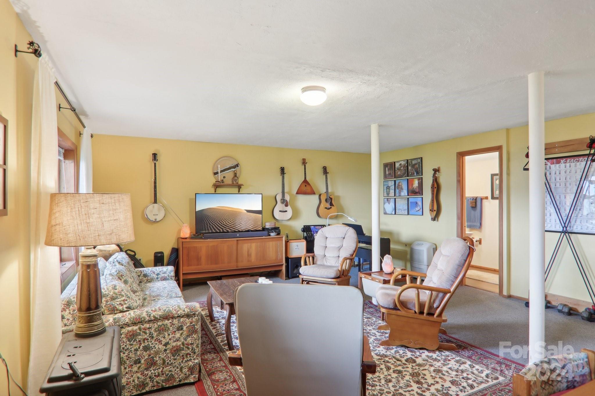 1685 Setzercove Road Maggie Valley, NC 28751 - Photo 24 of 42 a living room with furniture and a large window