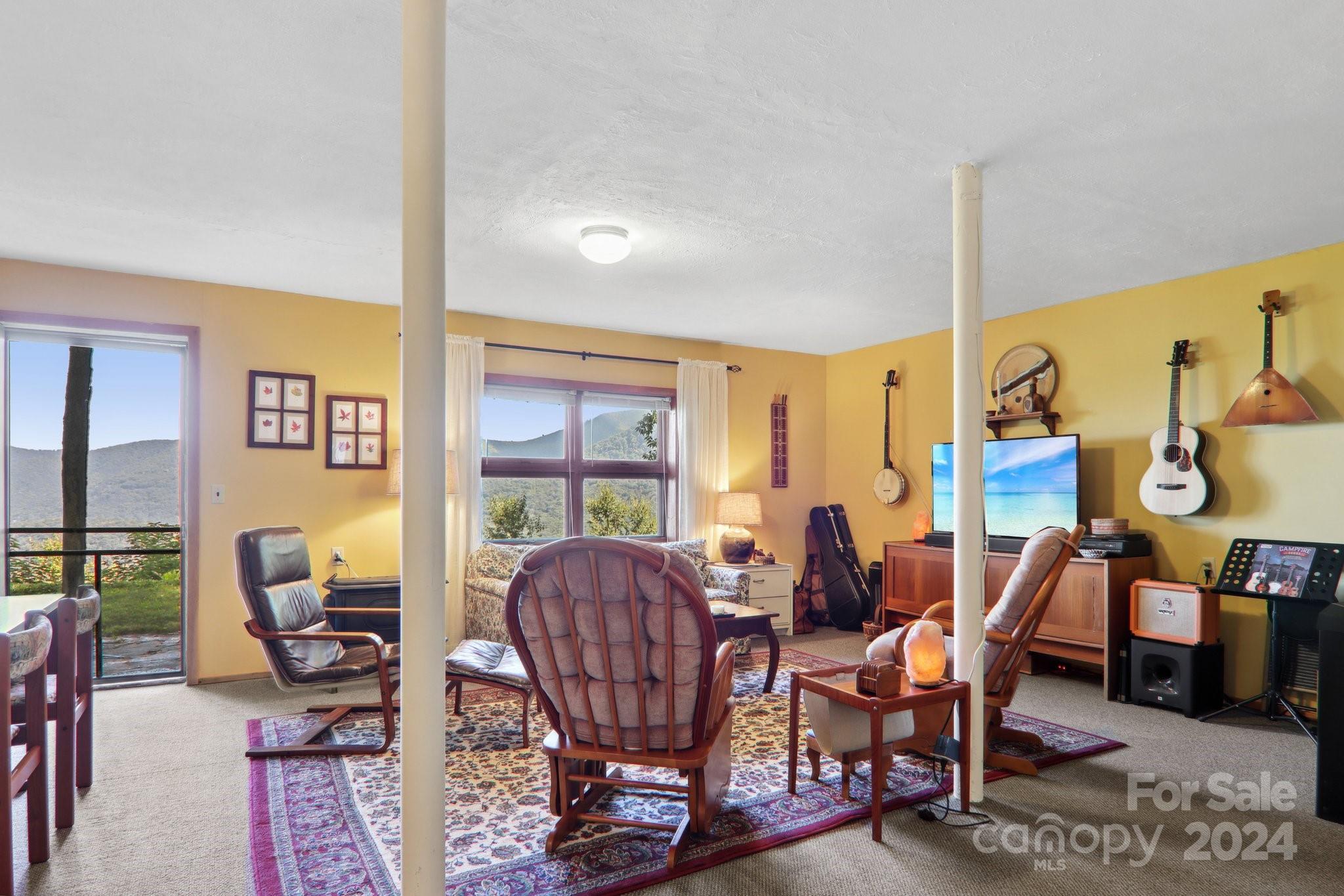 1685 Setzercove Road Maggie Valley, NC 28751 - Photo 25 of 42 a view of a dining room with furniture window and wooden floor