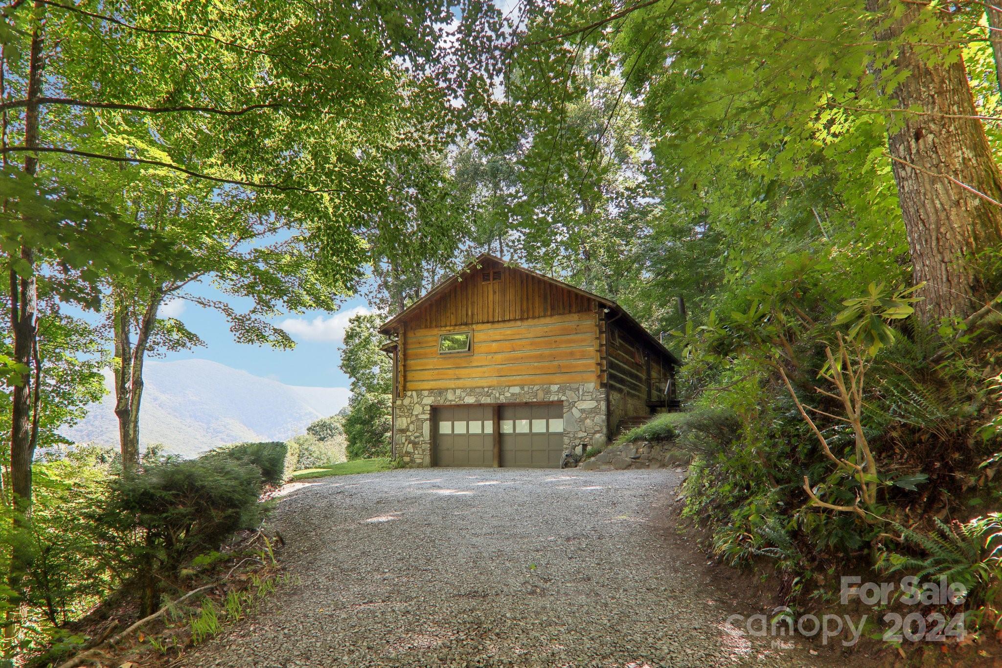 1685 Setzercove Road Maggie Valley, NC 28751 - Photo 35 of 42 a view of a wooden house with a yard and large trees