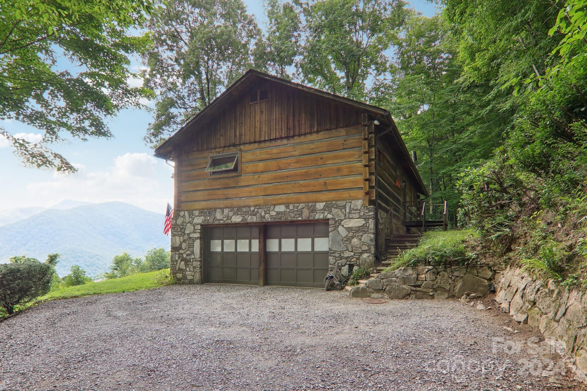 1685 Setzercove Road Maggie Valley, NC 28751 - Photo 39 of 42 a front view of a house with a yard and garage