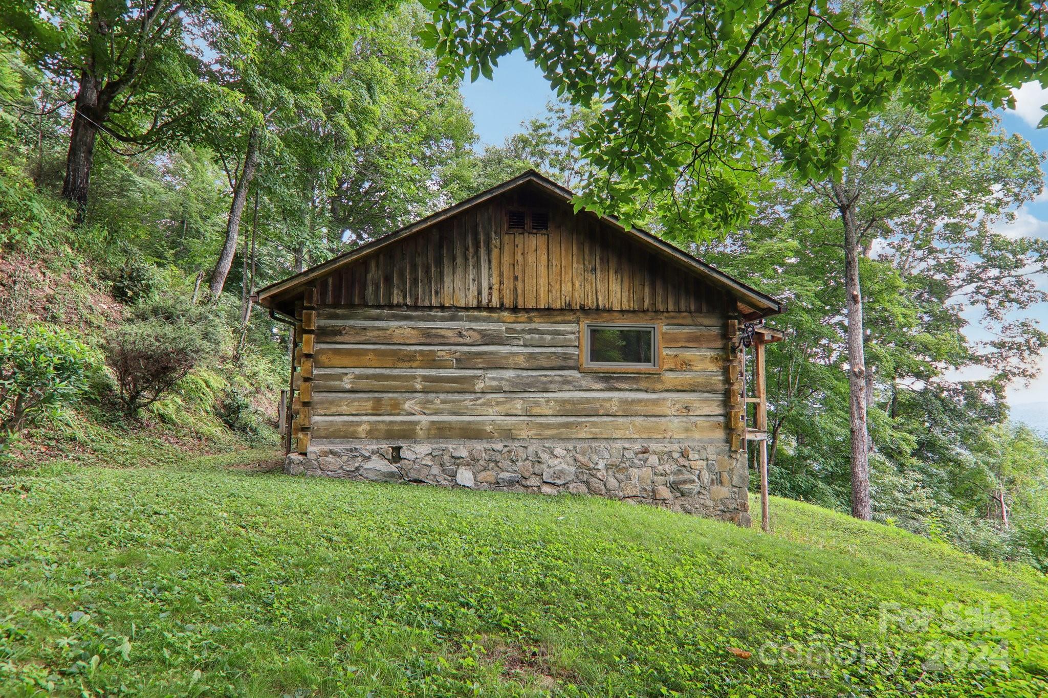 1685 Setzercove Road Maggie Valley, NC 28751 - Photo 8 of 42 a backyard of a house with lots of green space