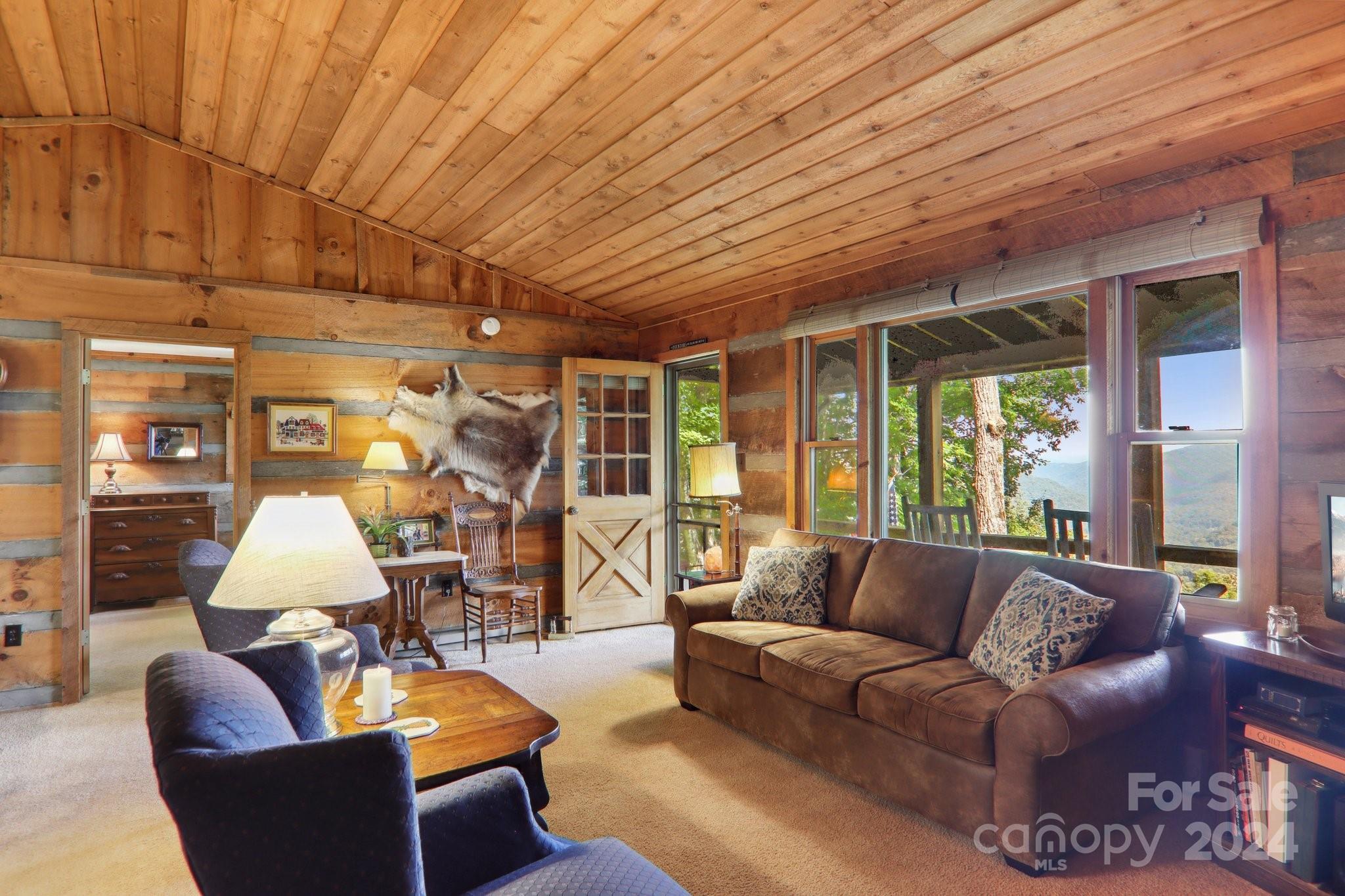 1685 Setzercove Road Maggie Valley, NC 28751 - Photo 10 of 42 a living room with furniture and a large window