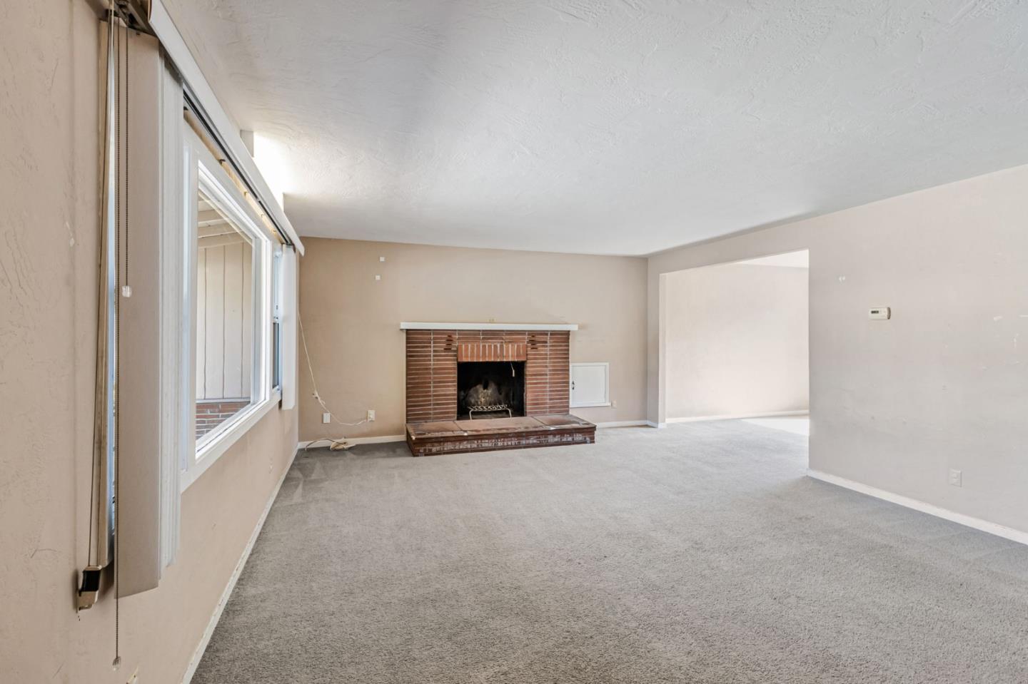 167 North Whisman Road Mountain View, CA 94043 - Photo 5 of 49 a view of an empty room with a fireplace and a window