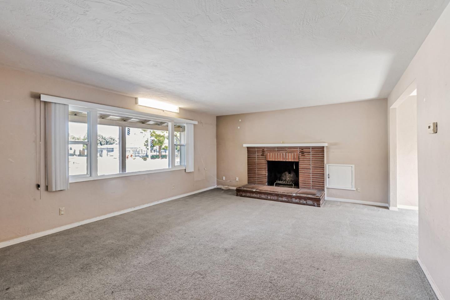 167 North Whisman Road Mountain View, CA 94043 - Photo 6 of 49 an empty room with windows and fireplace