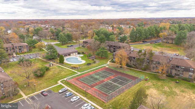 a view of a pool a dinning table and chairs in the patio
