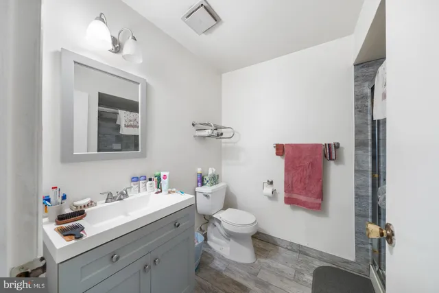 a bathroom with a sink mirror and toilet