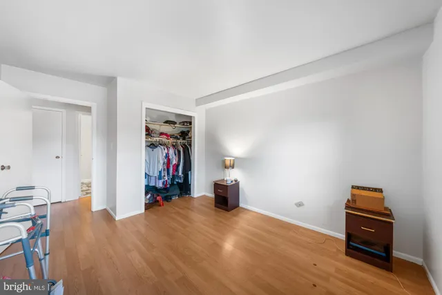 a view of a room with wooden floor and furniture