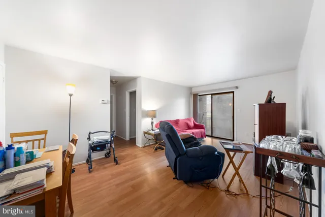 a living room with furniture a wooden floor and a flat screen tv