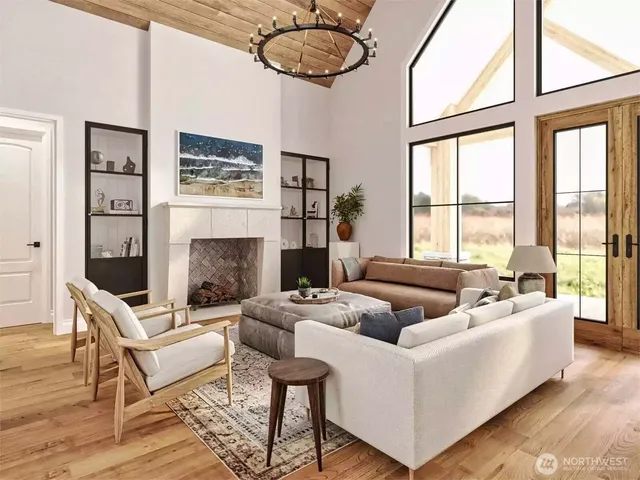 a living room with fireplace furniture and a large window