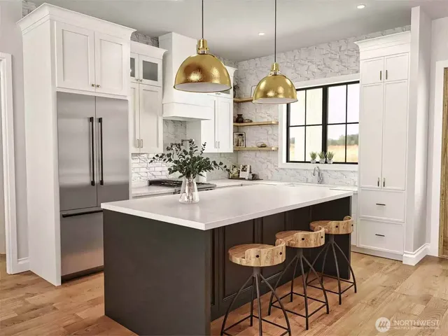 a kitchen with cabinets a center island and appliances