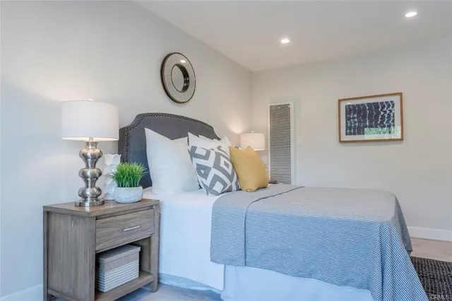 a bedroom with a bed and lamps