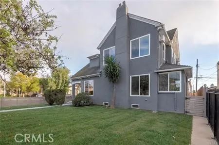 a house that has a tree in front of the house