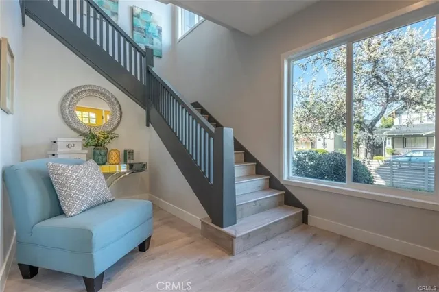 a view of entryway and hall with wooden floor