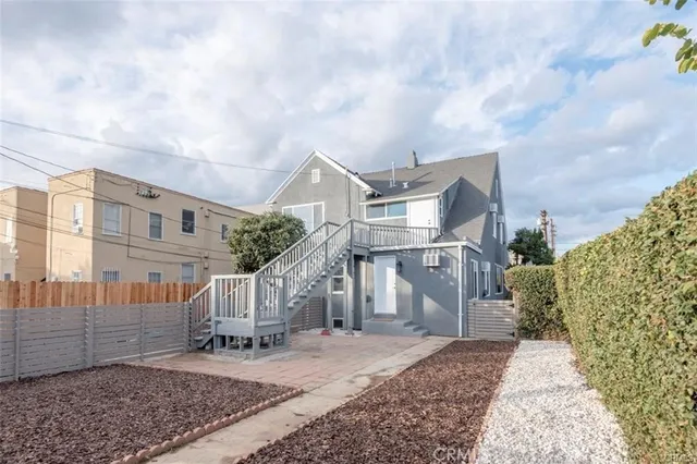 a front view of a house with garden and stairs