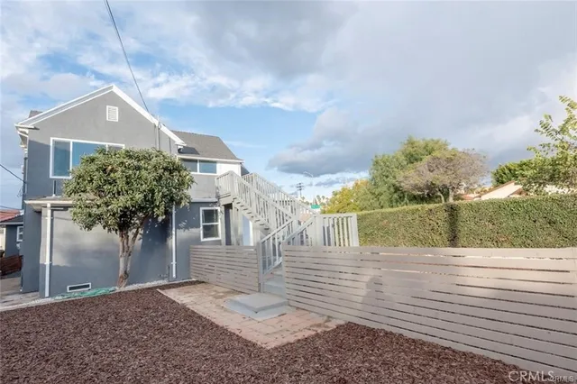 a view of a brick house next to a yard