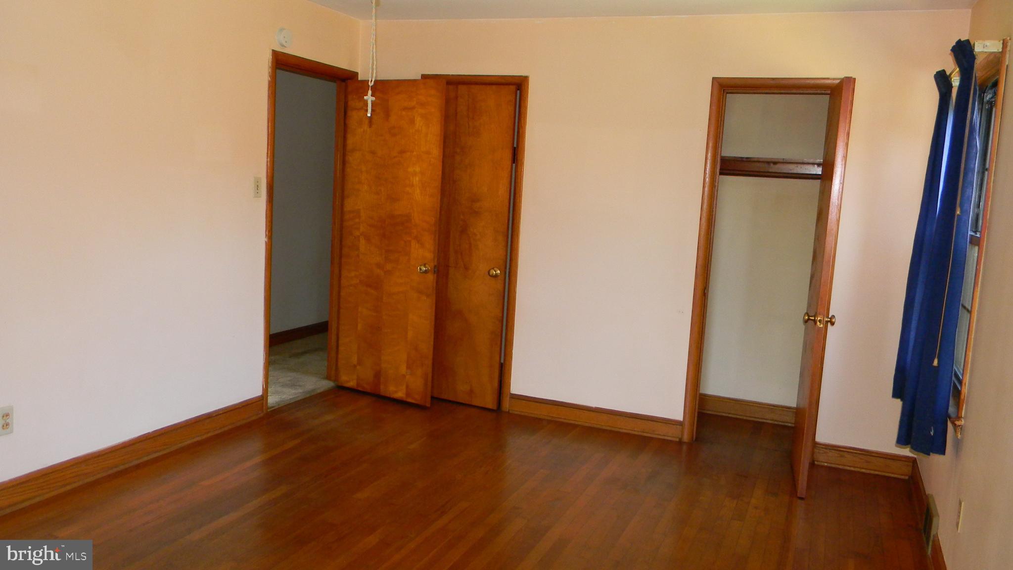 6688 Brocks Gap Road Broadway, VA 22815 - Photo 52 of 81 an empty room with wooden floor and closet