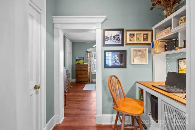 a view of a livingroom with furniture and a workspace