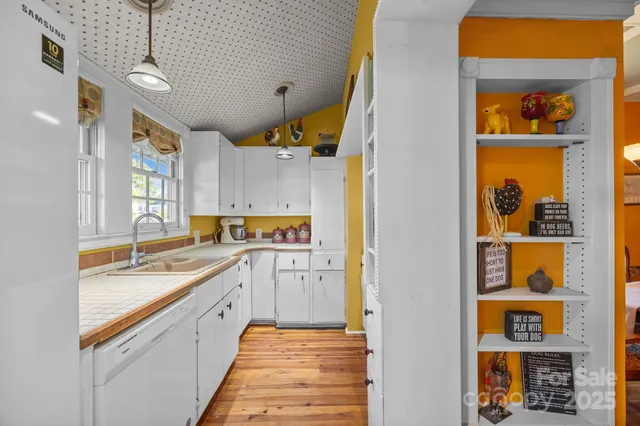 a kitchen with stainless steel appliances granite countertop a sink and cabinets