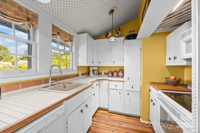 a kitchen with a sink a stove and cabinets