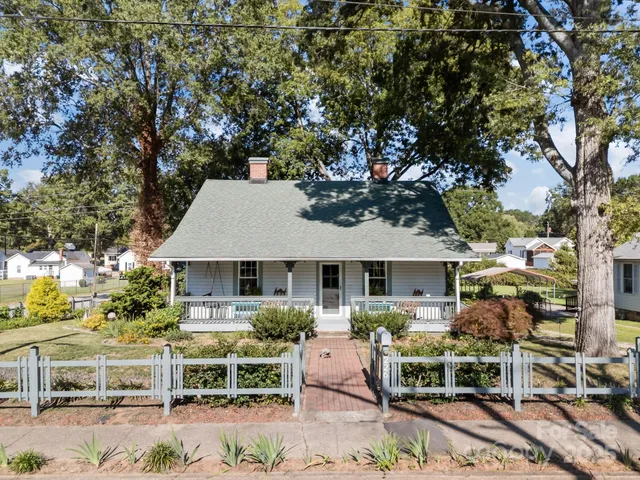 a front view of a house with sitting area