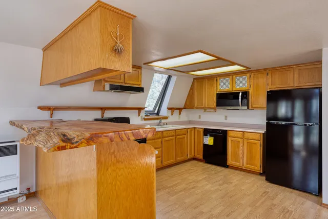 a kitchen with a stove top oven sink and a refrigerator